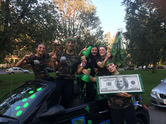 students piled in a hornet themed car